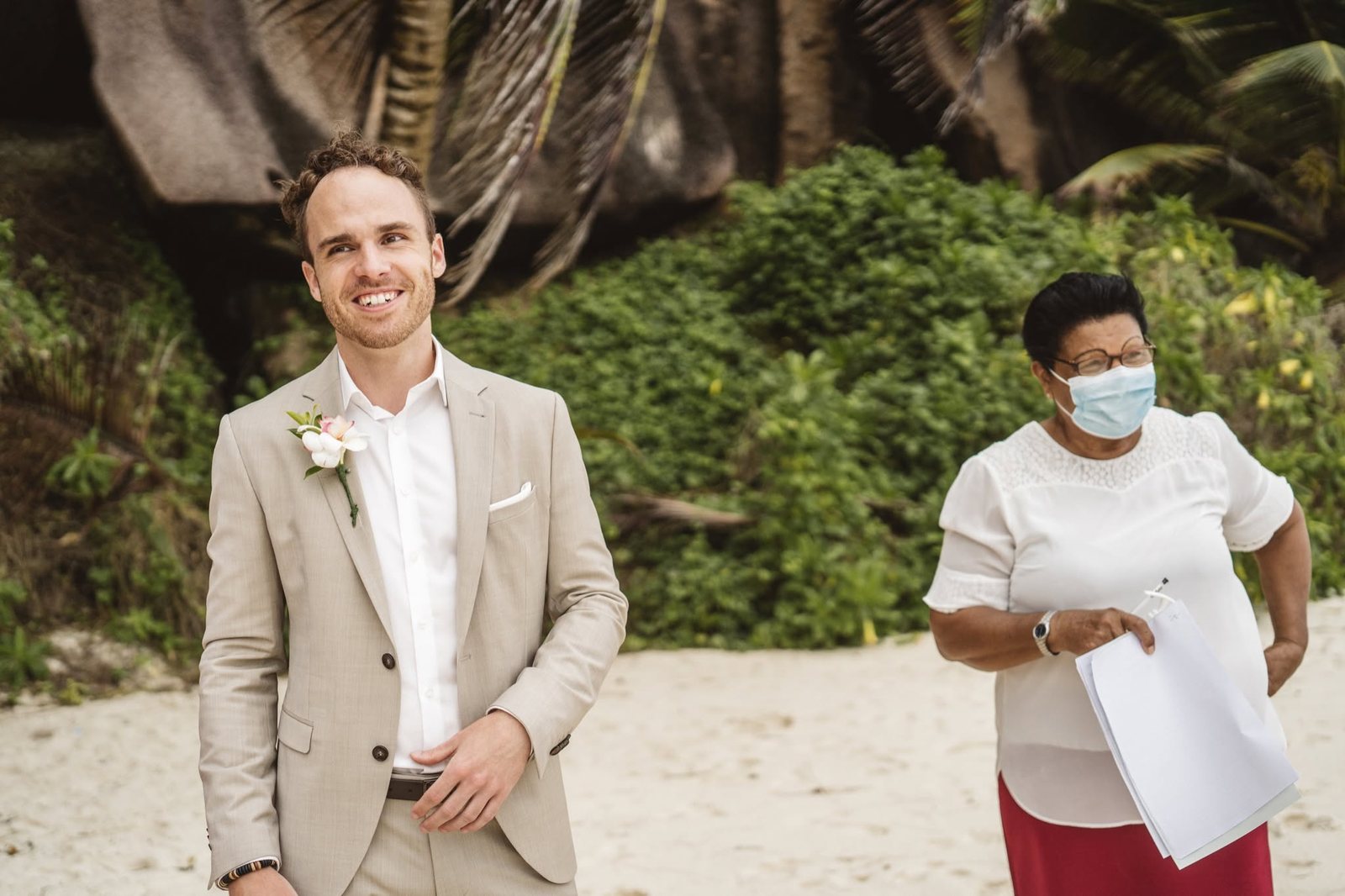 The groom with the marriage officer during the legal ceremony on La Digue