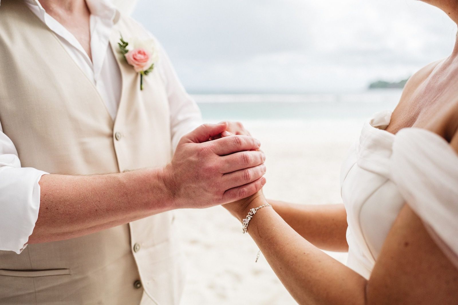 His hands holding hers against the linen waistcoat