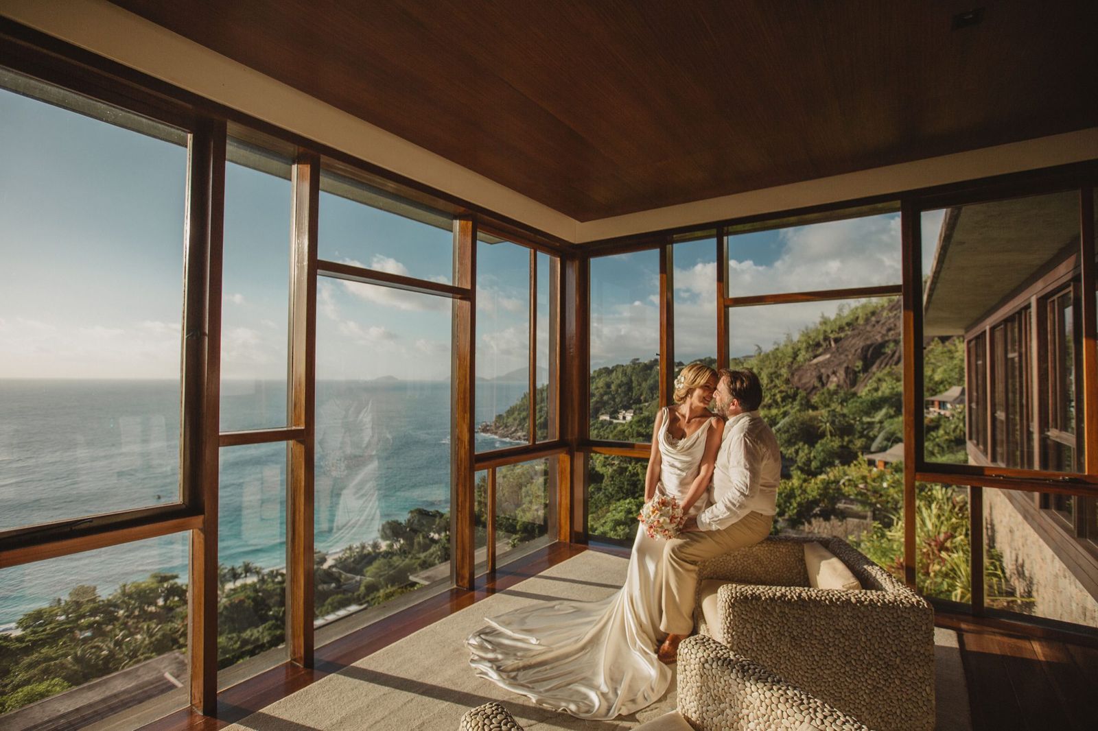 A quiet kiss in a window-lined room high above the coast
