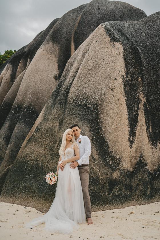 The two of them small against a towering wall of sculpted granite