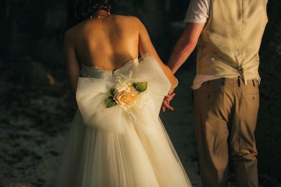 Evening light on the tulle bow and rose at the back of her dress