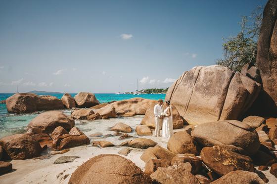 The two of them among giant rounded boulders at the water's edge