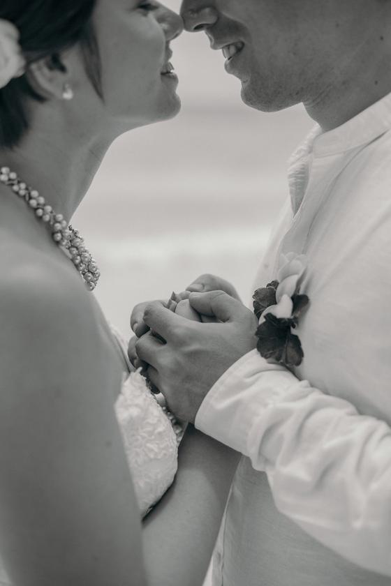 Noses touching, pearls and clasped hands, in black and white