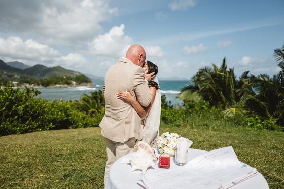 First kiss beside the signing table, a conch shell holding the papers