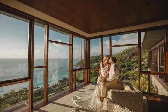 A quiet kiss in a window-lined room high above the coast